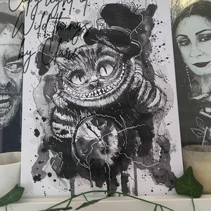 May include: A monochrome illustration of the Cheshire Cat from Alice in Wonderland, featuring a top hat and pocket watch. The artwork uses a watercolour effect with ink splatters and includes the text "Copyright of Wild Things by Clare".