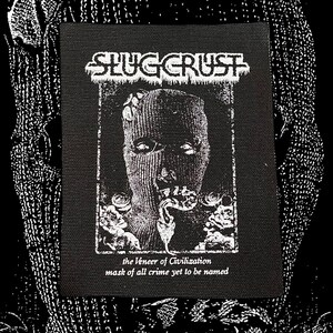 May include: Black and white patch with the text "SLUGCRUST" in a stylized font. The patch features a masked figure with a snake coming out of its mouth. The text "the veneer of Civilization mask of all crime yet to be named" is below the figure.