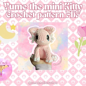 May include: A pink crochet kitten with large eyes and white accents is featured in this image. The text "Yume the mini Kitty Crochet pattern PDFs" is displayed at the top. The background is pink with paw prints and a crescent moon and star graphic.