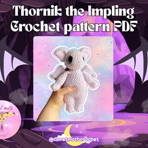 May include: A crocheted imp plushie with wings, held in a hand, against a backdrop with the text "Thornik the Impling Crochet pattern PDF". The plushie is light purple with large black eyes. The background is purple and pink.