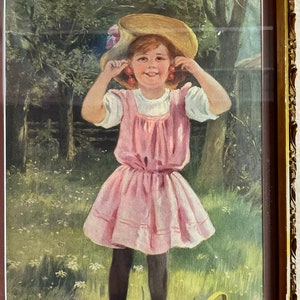 Vintage little girl in pink dress with cherry earrings in print in antique frame