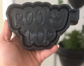 May include: Black 3D printed mold for resin casting. The mold is shaped like a cloud and says "Rocky Top" in a stylized font.