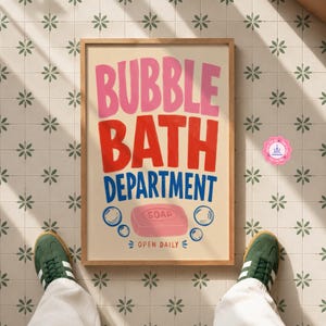 May include: A rectangular framed wall art print with a cream background featuring the text BUBBLE BATH DEPARTMENT in pink, red, and blue. Below the text is a pink bar of soap with the word SOAP printed on it, surrounded by blue bubble outlines.