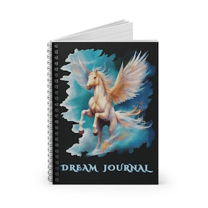May include: Spiral-bound notebook with a black cover featuring a watercolor illustration of a white winged horse against a blue and teal background. The words "DREAM JOURNAL" are printed in white at the bottom.