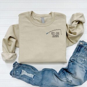 a t - shirt that says reel cool grandpa on it