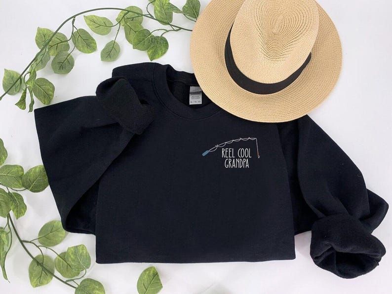 a t - shirt that says reel cool grandpa on it