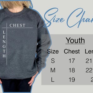 May include: Size chart for youth sweatshirts. The chart shows chest and length measurements in inches for sizes S, M, and L.