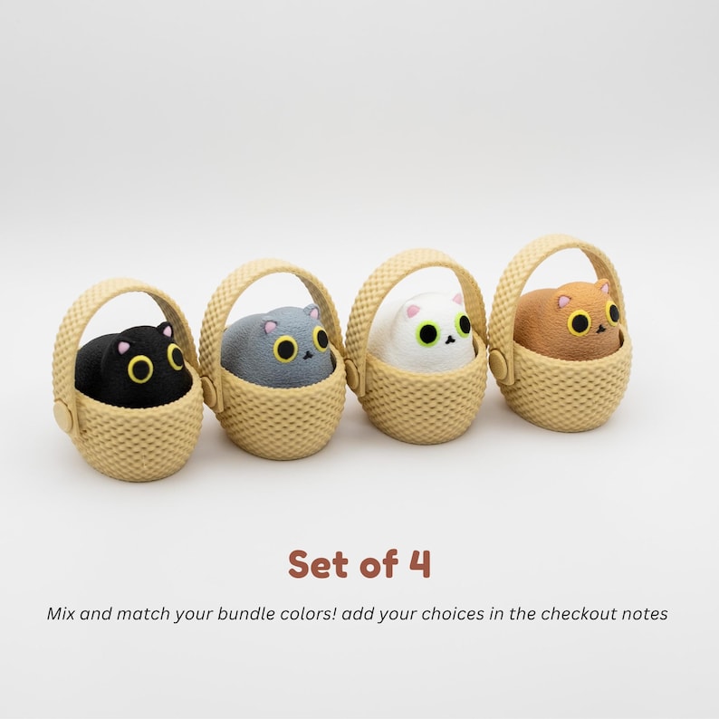 May include: A set of four small figurines, each featuring a cat with large yellow eyes sitting inside a textured beige basket. The cats are black, gray, white, and brown. The text reads: Set of 4. Mix and match your bundle colors! add your choices in the checkout notes.