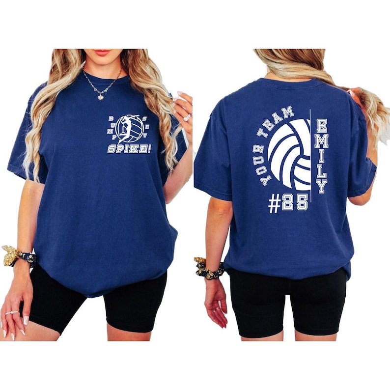 May include: A navy blue t-shirt with a white volleyball graphic and the text "Spike!" on the front. The back of the shirt has the text "Your Team" and "Emily #25" with a volleyball graphic.