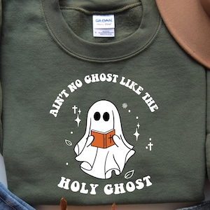 May include: A green sweatshirt with the text "Ain't no ghost like the Holy Ghost" and a cartoon ghost holding a book.