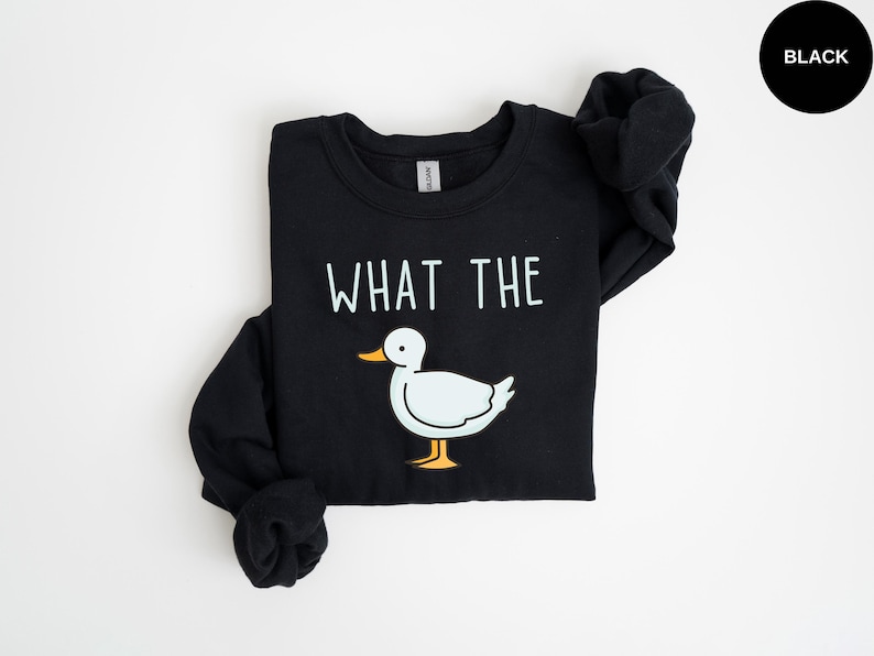 May include: Black sweatshirt with a white duck and the text "What the" printed on the front.