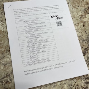 May include: A printed workbook page detailing maths lessons, covering topics such as fractions, decimals, and equations. The text "Where's Mom?" is in the upper right corner. The page is on a light-coloured surface.