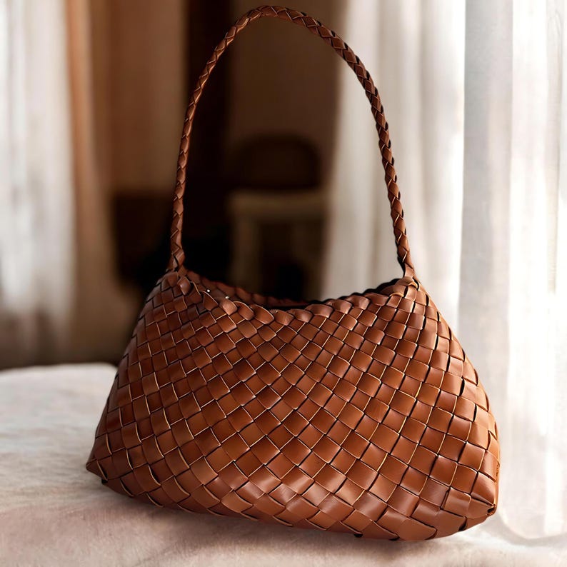 May include: A brown woven leather handbag with a single top handle.