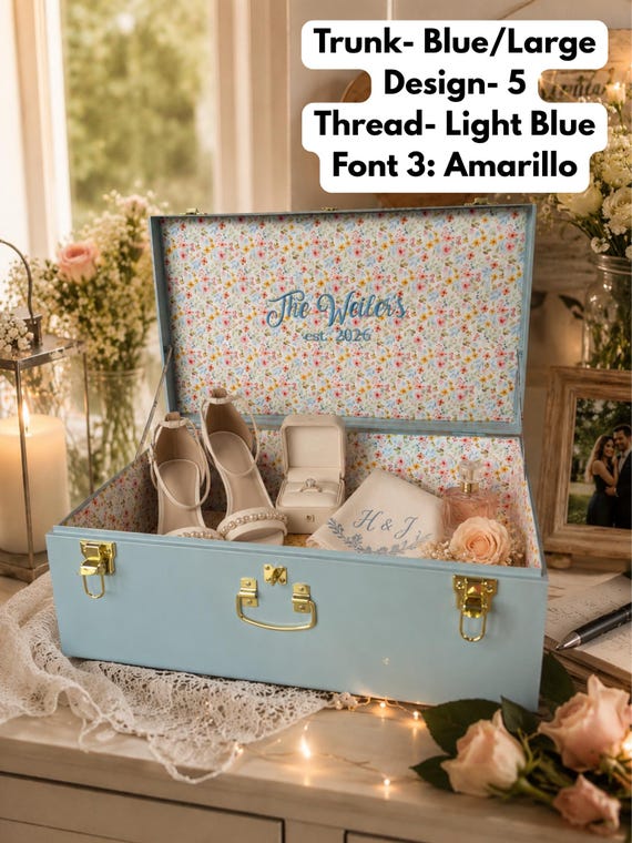 A fabric-wrapped, custom-embroidered metal trunk that doubles as a heirloom-grade memory chest — 268 favorites don't lie, this thing looks stunning.
