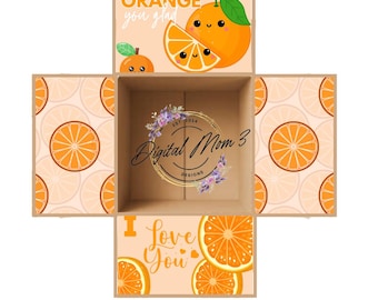 May include: A brown cardboard box with a cute orange design. The box has a lid that lifts to reveal a smaller box inside. The lid has the text "ORANGE you glad" and a cartoon orange with a smiling face. The smaller box has the text "I love you" and a pattern of orange slices. The box is perfect for a gift or a special occasion.