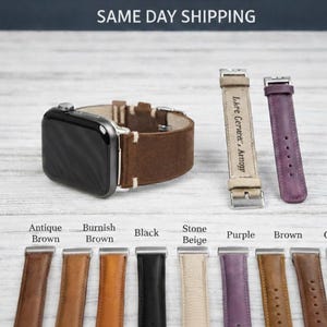 May include: An Apple Watch with a brown leather band is displayed, along with several replacement bands in various colors: antique brown, burnish brown, black, stone beige, purple, brown, and gray. The text "SAME DAY SHIPPING" is visible.