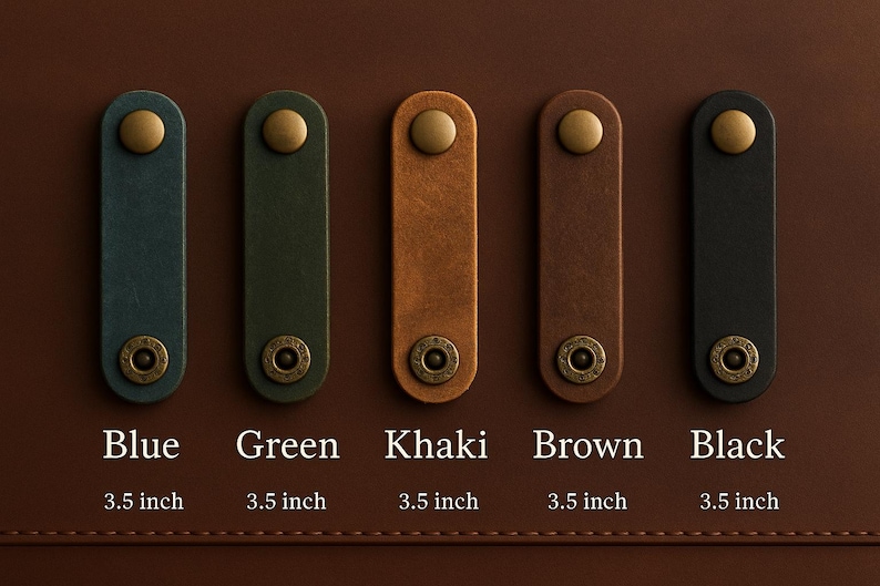May include: Five leather pull tabs in blue, green, khaki, brown, and black, each with a brass rivet and a gold-colored stud. Each tab is 3.5 inches long. The tabs are displayed on a brown surface.