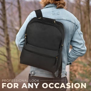 May include: A black backpack with multiple zippered compartments and gold-colored hardware. The backpack is worn over the shoulders. The text at the bottom reads: PROFESSIONAL LOOK FOR ANY OCCASION.