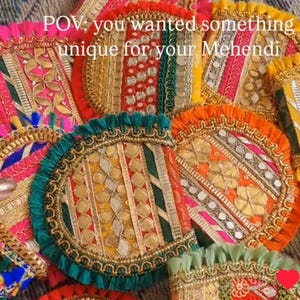 May include: A collection of colorful, intricately decorated round objects, possibly decorative trays or fans, with vibrant hues of pink, orange, green, and gold. The text "POV: you wanted something unique for your Mehendi" is visible.