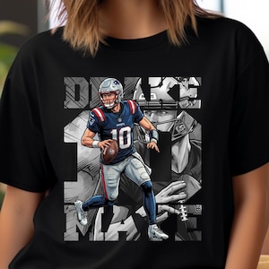 May include: Black t-shirt with a graphic of a football player in a Patriots uniform, holding a football. The design includes the player's name and number, with a grayscale background. The shirt has a classic crew neck.