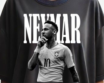 May include: Black t-shirt with a white graphic of Neymar Jr. wearing a Brazil soccer jersey with the number 10 on it. The word "NEYMAR" is printed in large white letters above the image.