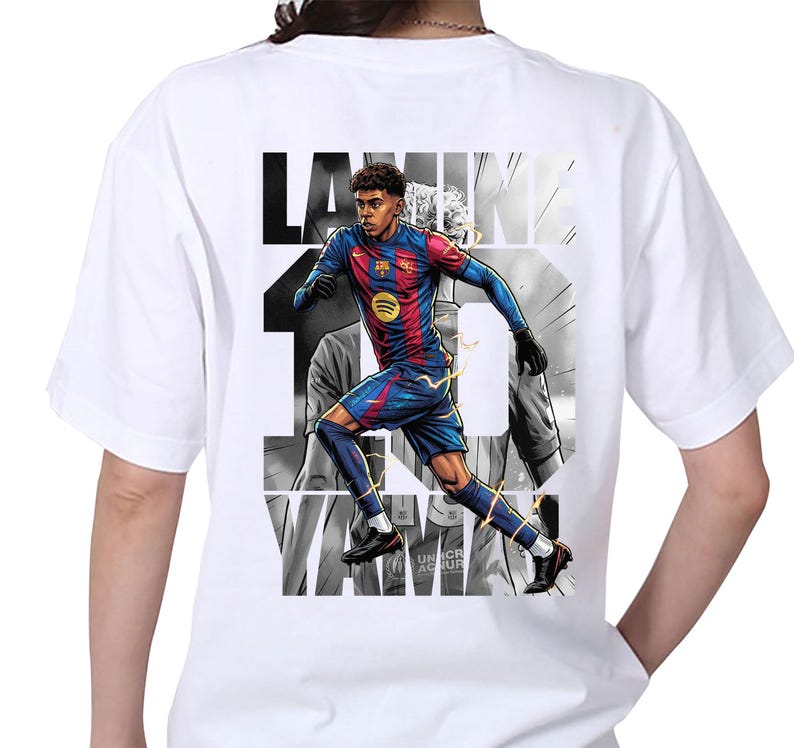 May include: White t-shirt featuring a graphic of a soccer player in a blue and red uniform, with the name "LAMINE" and the number "19" printed on the back. The design includes a Spotify logo and the text "UNHCR AC NUR".