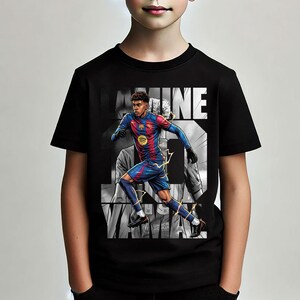 May include: Black t-shirt featuring a graphic of a soccer player in a red and blue uniform, with the name "LAMINE" in white block letters. The shirt also has the Spotify logo and the text "UNHCR".
