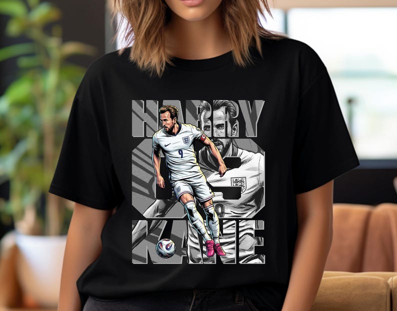 May include: Black t-shirt featuring a graphic of soccer player Harry Kane in a white uniform with the number 9. The name "HARRY KANE" is printed in large, gray block letters. A soccer ball is at the bottom of the graphic.