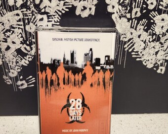May include: A cassette tape with a red and orange background featuring the title "28 Days Later" and a biohazard symbol. The text "Original Motion Picture Soundtrack" and "Music by John Murphy" are also visible.
