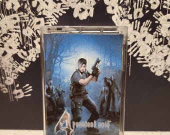 May include: A clear plastic case with a blue and white image of a man holding a gun in a forest. The text "Resident Evil 4 Original Soundtrack Vol. 3" is printed on the case.