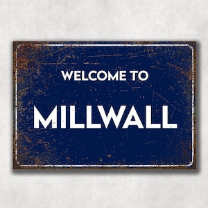May include: A blue metal sign with a rusty texture. The sign says "Welcome to Millwall" in white letters.