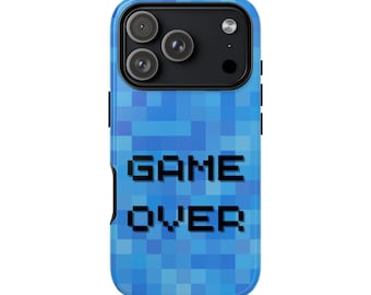 May include: A blue pixelated phone case with the words "GAME OVER" in black block letters. The case has a camera cutout at the top and is designed to fit a smartphone. The background is a mosaic of blue squares.