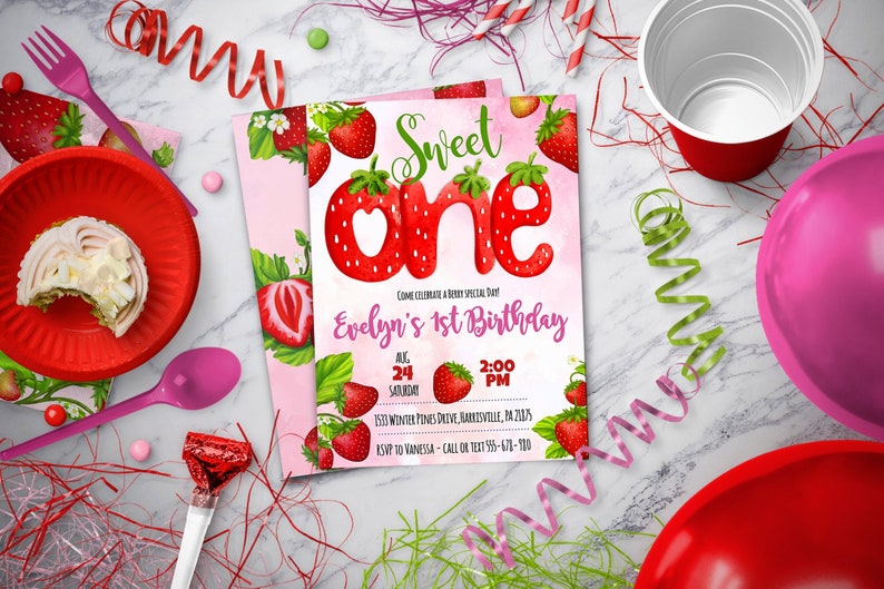 May include: A pink and green birthday invitation with a strawberry theme. The invitation says "Sweet One" with a large strawberry number one. The text says "Evelyn's 1st Birthday" and includes the date, time, and location of the party.