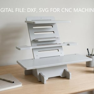 May include: A gray wooden standing desk with multiple shelves and a slatted back. The desk is on a light wood surface. The text "DIGITAL FILE: DXF, SVG FOR CNC MACHINES" is at the top of the image.