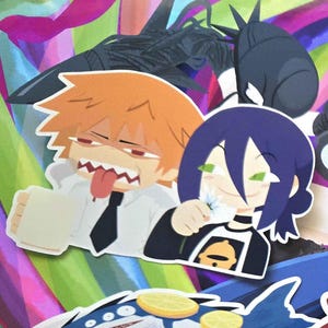 May include: A collection of colorful anime-style stickers featuring various characters. The stickers showcase characters with distinctive hairstyles, facial expressions, and attire. The background is a vibrant mix of colors.