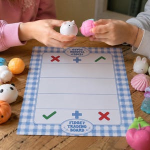 May include: A rectangular fidget trading board with a blue and white gingham border, featuring a central grid with red X, green checkmark, and blue plus symbols. The board is surrounded by various colorful, small, soft silicone squishy toys.