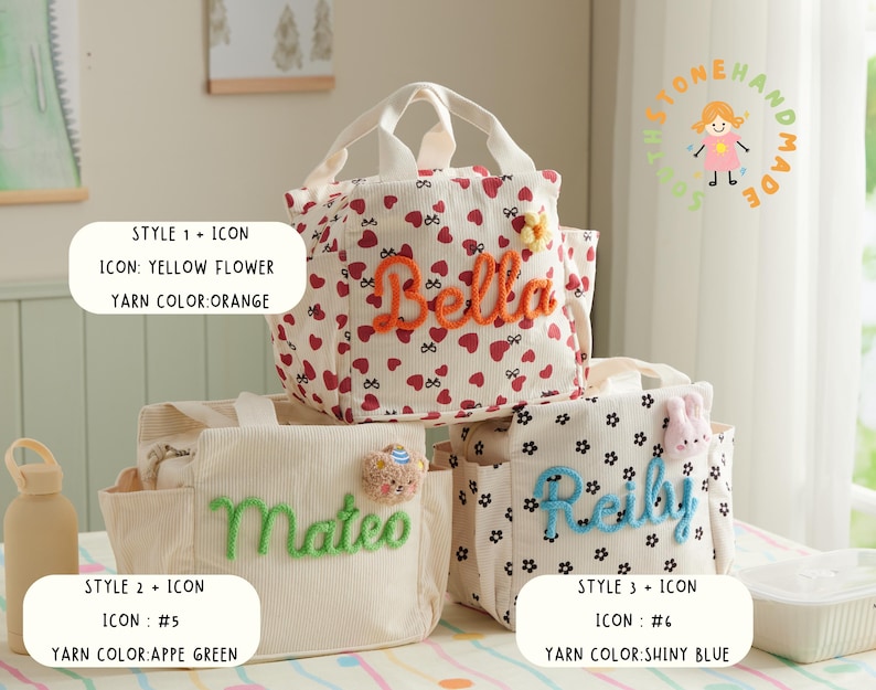 May include: Three personalized lunch bags with different designs. One bag is white with red hearts and the name "Bella" in orange yarn. Another is beige with "Mateo" in green yarn. The third is white with black flowers and "Reilly" in blue yarn.