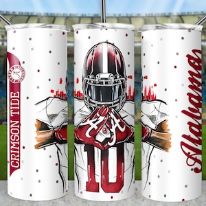 May include: White tumbler with a red and black football player graphic, the text "Crimson Tide" and a red and black Alabama logo. The background is white with small red and gray dots.