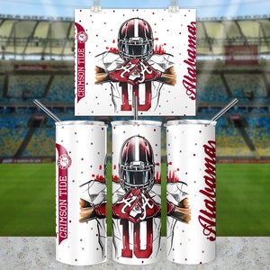 May include: Three white tumblers with a white background and black polka dots. The tumblers feature a cartoon image of a football player wearing a red and white uniform with the words "Crimson Tide" and "Alabama" on the sides.