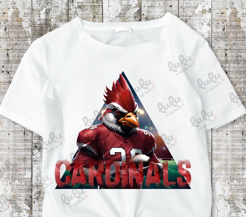 Pu&ograve; includere: Maglietta bianca con un cardinale rosso che indossa una divisa da football e la parola "CARDINALS" in un triangolo.