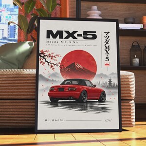Puede incluir: Un póster enmarcado que muestra un Mazda MX-5 NA descapotable rojo desde la parte trasera. El fondo presenta un gran sol rojo, el monte Fuji y una rama de cerezo. El texto incluye "MX-5", "Mazda MX-5 NA" y caracteres japoneses.