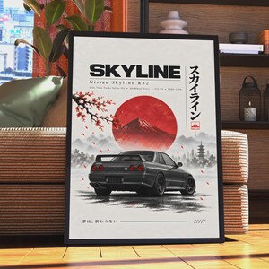 Könnte beinhalten: Ein gerahmtes Poster mit einem grauen Nissan Skyline R32 von hinten vor weißem Hintergrund mit einer großen roten Sonne, einem Berg und Kirschblütenzweigen. Der Text lautet SKYLINE, Nissan Skyline R32 und japanische Schriftzeichen.