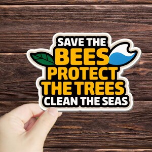 May include: White sticker with a yellow, black, and blue design. The sticker says "Save the Bees Protect the Trees Clean the Seas".