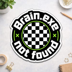 May include: A round sticker with the text "Brain.exe not found" in a black and white design. The sticker features a checkered pattern in the center, a neon green outline, and a black border.