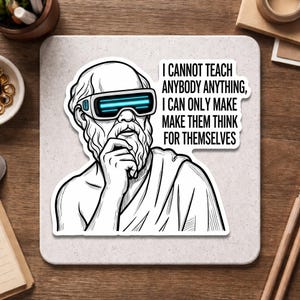 May include: A black and white sticker featuring a stylized illustration of a philosopher wearing futuristic glasses. The sticker includes the quote: "I CANNOT TEACH ANYBODY ANYTHING, I CAN ONLY MAKE THEM THINK FOR THEMSELVES."