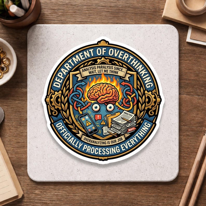 May include: A sticker with a detailed design featuring the words "DEPARTMENT OF OVERTHINKING" in a circular emblem. The design includes a brain, a smartphone, and stacks of papers. The text "OFFICIALLY PROCESSING EVERYTHING" is also present.