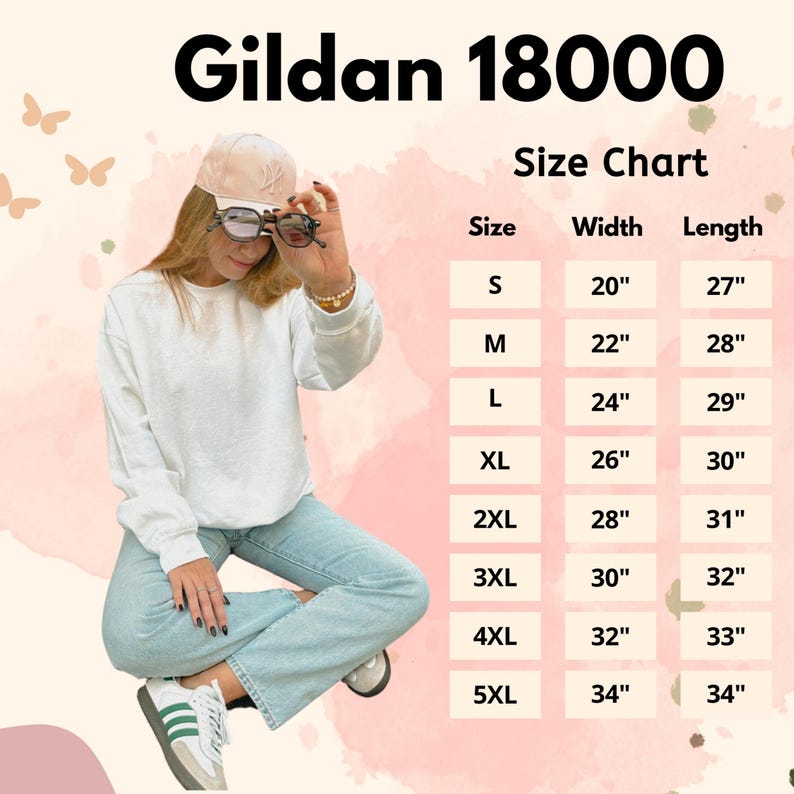 Puede incluir: Una sudadera blanca Gildan 18000 con una tabla de tallas. La tabla enumera las tallas S a 5XL, con las medidas de ancho y largo en pulgadas. La modelo lleva la sudadera y unos vaqueros azul claro.