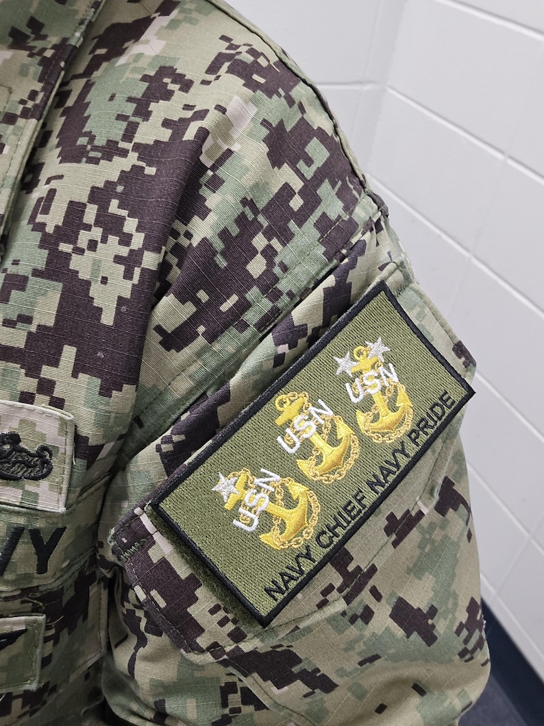 Embroidered military patch attached to a Navy Working Uniform sleeve, showcasing three gold USN anchors with stars representing Chief, Senior Chief, and Master Chief ranks. The patch reads 'NAVY CHIEF NAVY PRIDE' in black lettering on an olive background.