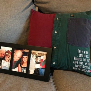 May include: A black framed photo collage with four family photos, next to a pillow made from a green and burgundy shirt. The pillow has a pocket and buttons, with text that reads "THIS IS A SHIRT I USED TO WEAR...LOVE GRANDDAD 2018."