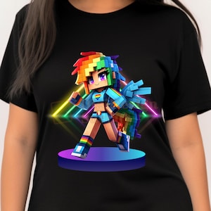 May include: Black t-shirt featuring a colorful, pixelated character with rainbow hair, wings, and clothing. The character is standing on a purple platform with neon lights in the background. The design has a vibrant, digital art style.